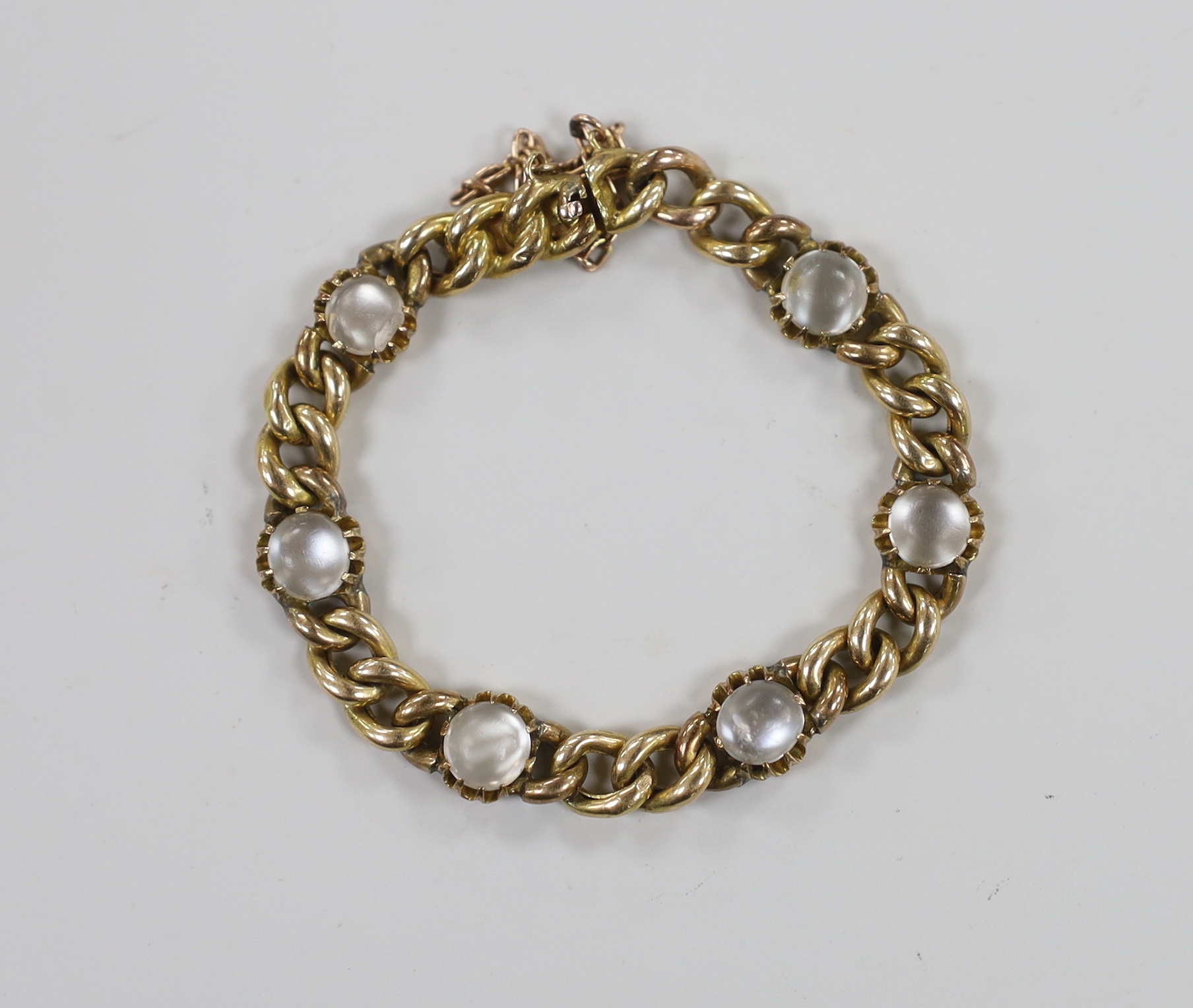 An Edwardian 15ct gold and six stone cabochon moonstone set child's curb link bracelet, 12cm, gross weight 9.3 grams.